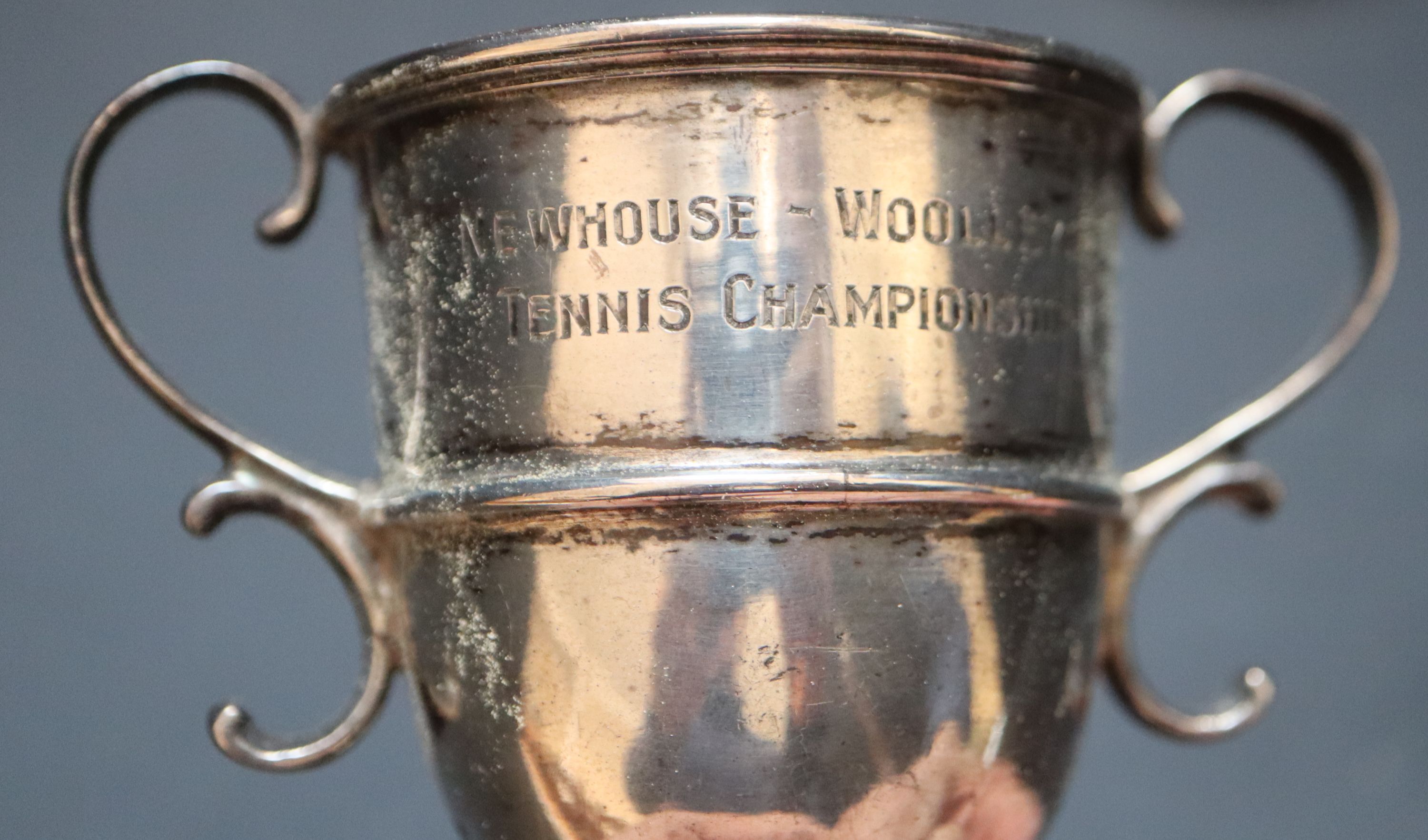 Two small silver trophy cups, largest 97mm, a modern silver gilt beaker and a group of assorted plated travelling beakers.